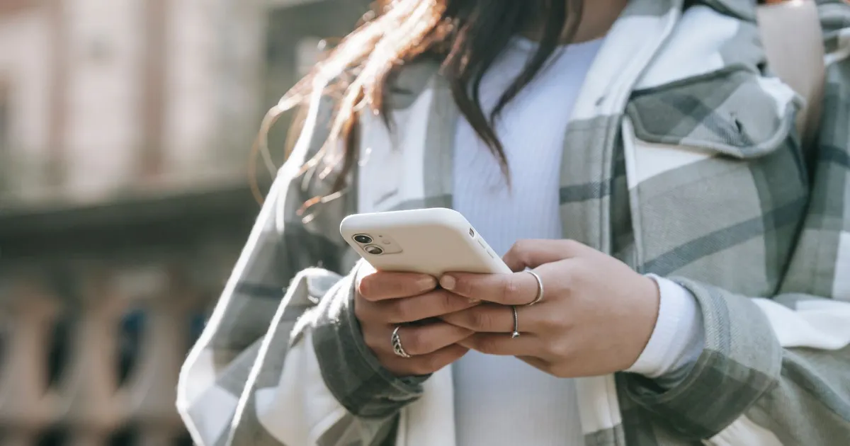 Person checking an Interac deposit notification on a phone in the evening, the moment e-transfer loans Hamilton lenders send arrive